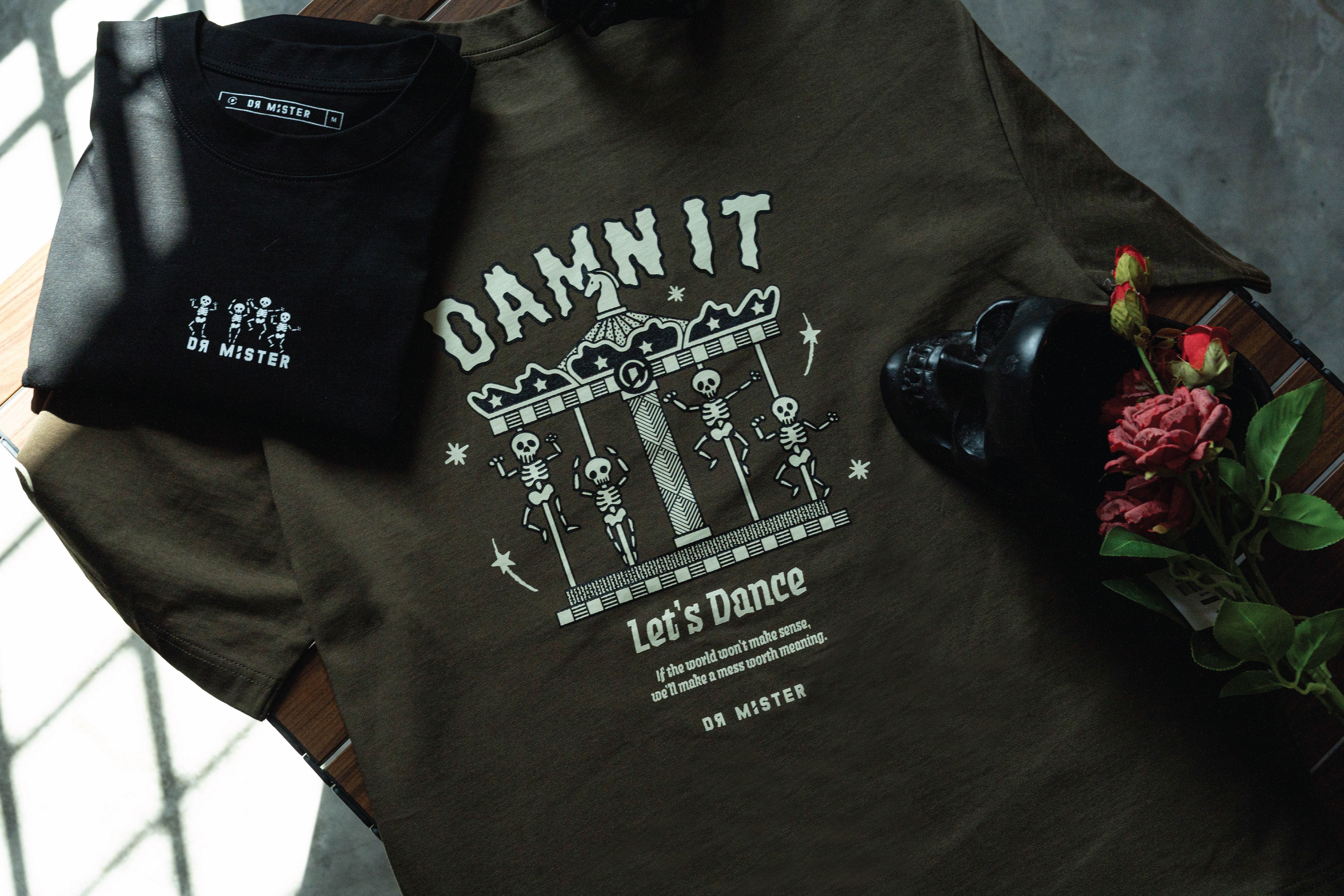 “Damn It” Dancing Tee Back with New Addition